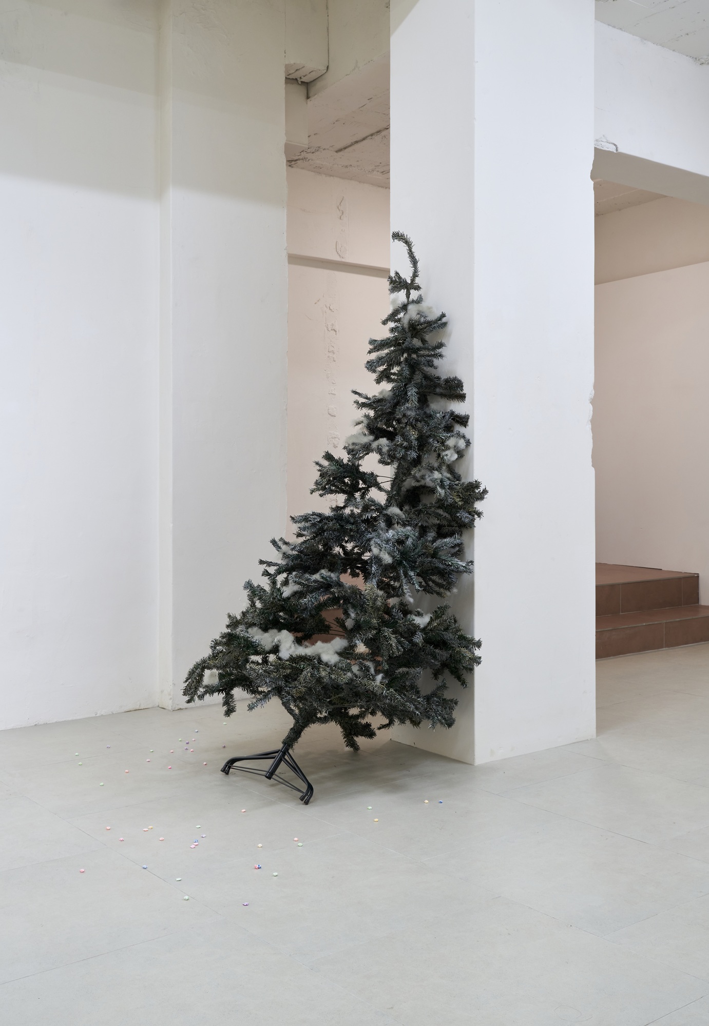 Euysun Kim, Hani Yikyung Han, Expired glow, 2026, painted christmas tree, cotton, glitter, water-based paint, nail polish, acrylic on folded paper, dimensions variable