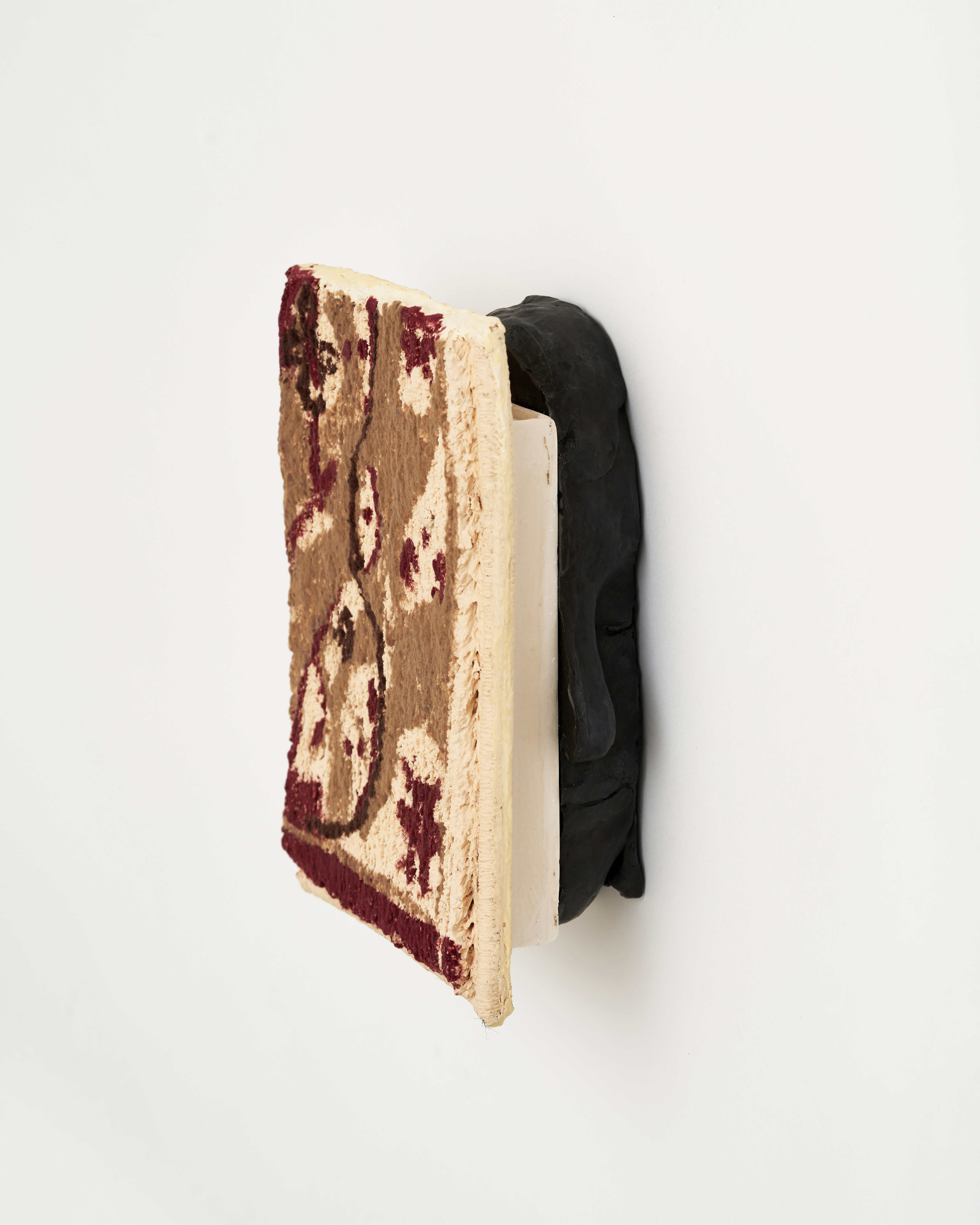 Lee Doyub, Rug/Book/Head, 2023, velvet, Jesmonite, resin, adhesive, and wall, 25.5x19x9cm